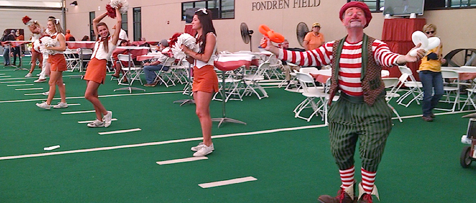 Bonzo the Clown cheering with the University of Texas cheerleaders.