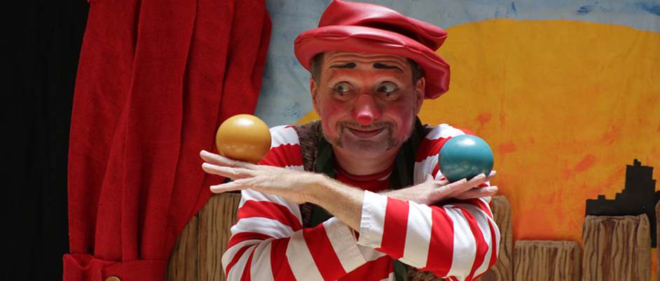 Bonzo the Clown juggling colorful balls.
